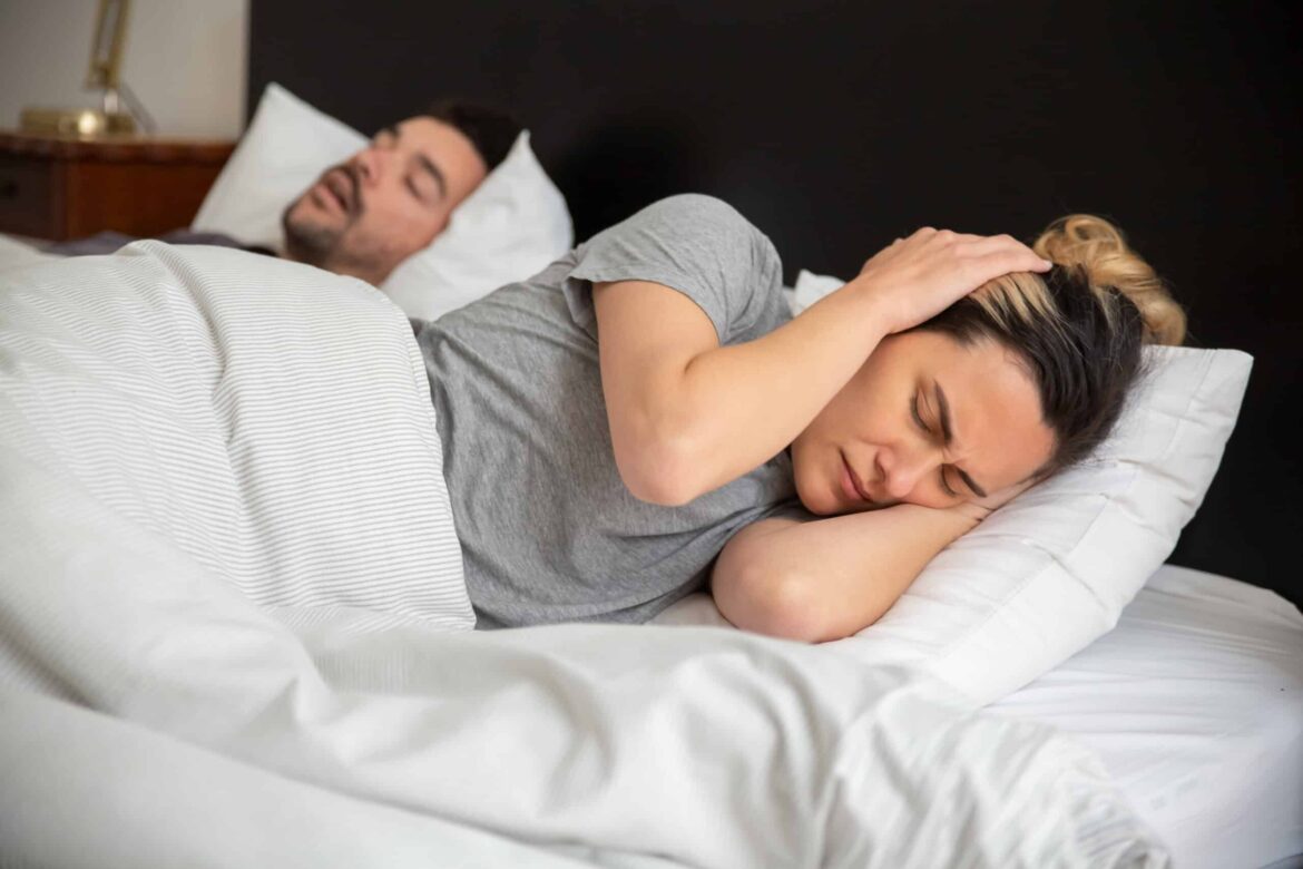 woman in gray shirt lying on bed stockpack pexels scaled