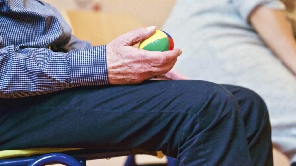 Person holding multicolored ball