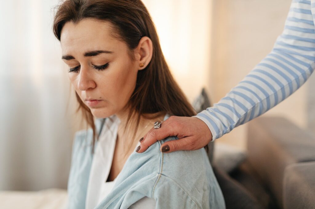 a person tapping a woman s shoulder